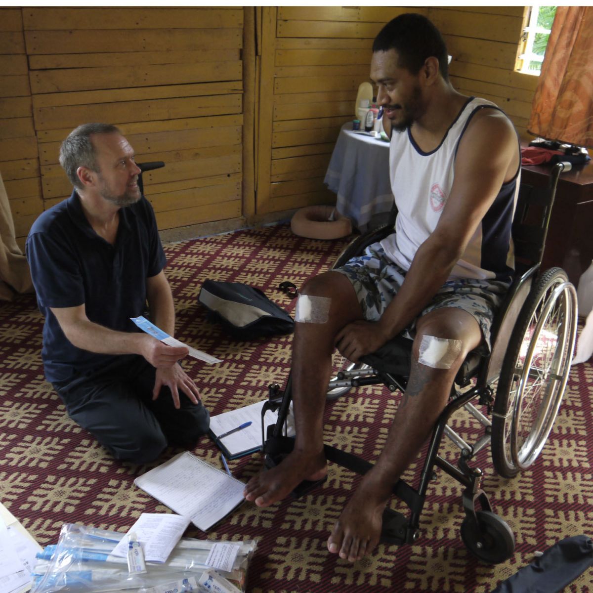 Motivation Australia staff present wheelchair user with Paralogic products in Fiji